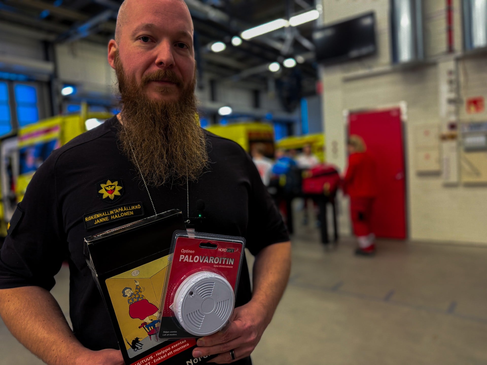 Pelastaja pitää kädessään palovaroitinta.